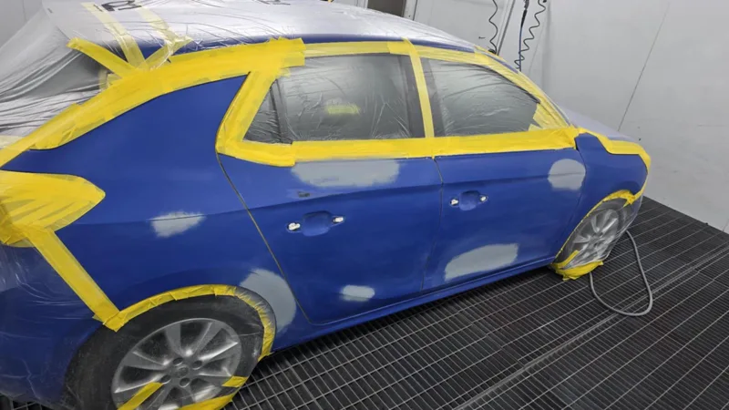 Vehicle receiving professional dent repair in the workshop